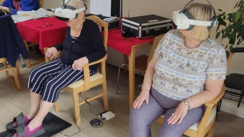 Care home residents wearing VR headsets