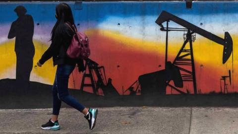 A mural alluding to oil companies outside one of the offices of the state-owned company Petroleos de Venezuela