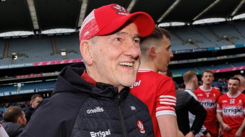 A delighted Mickey Harte celebrates with his Derry team after beating Dublin at Croke Park