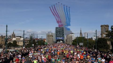 Runners cross the Tyne bridge as Red Arrows fly over