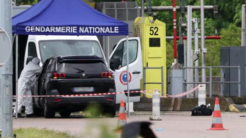 A forensic is at work at the site of a ramming attack which took place late morning at a road toll in Incarville in the Eure region of northern France, on 14 May 2024