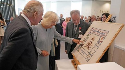 King Charles and Queen Camilla look at new panel on Great Tapestry of Scotland