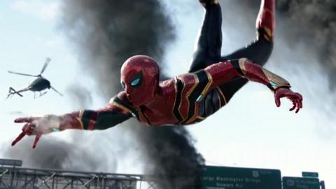 A scene from Spider-Man: No Way Home. Spider-Man is in the air and is about to fire a web.