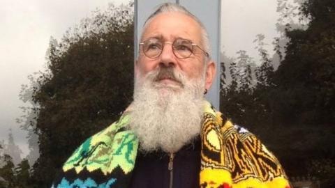 David Shenton wearing a hand-knitted scarf