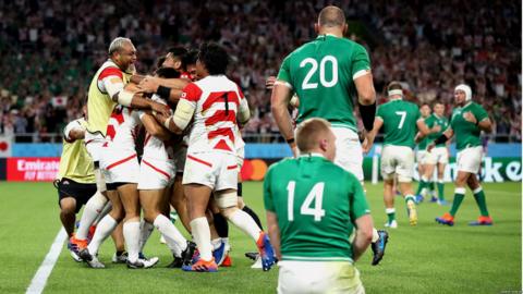 Japanese players celebrate their shock victory against Ireland, scoring 19-12 in a Pool A game.