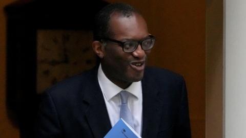 Kwasi Kwarteng walks out of Downing Street with a smile
