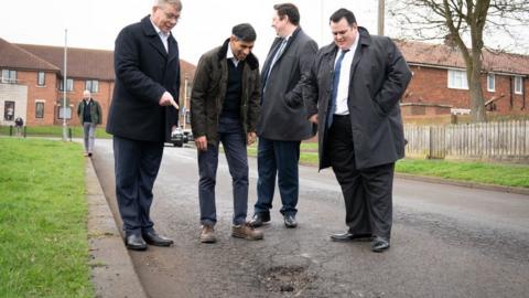 Prime Minister Rishi Sunak looking at a pothole in Darlington with council leader Jonathan Dulston (far right), Tees Valley Mayor Ben Houchen (second from right) and Darlington MP Peter Gibson (far left)