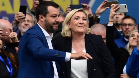 Italian Deputy Prime Minister and Interior Minister Matteo Salvini (L) and President of the French far-right Rassemblement National (RN) party Marine Le Pen react on stage at a rally of European nationalists ahead of European elections on May 18, 2019