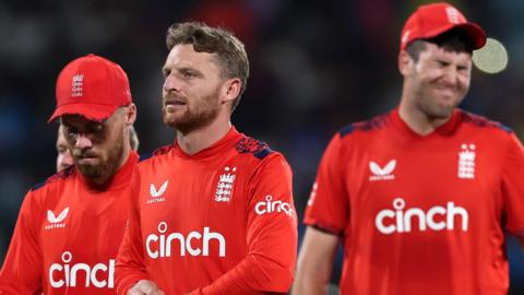 England players look dejected as they walk off after defeat by India