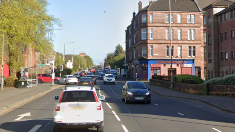 A google view of Dumbarton Road, busy with cars travelling in both directions