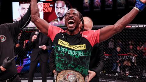 Jason Jackson celebrates winning the welterweight title at Bellator 301