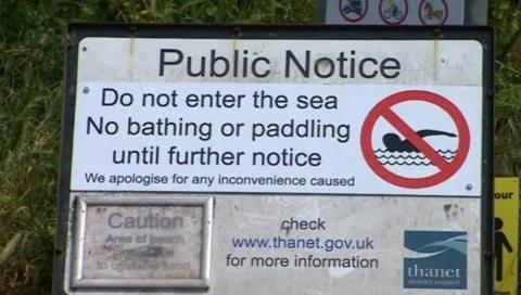 A sign warning people "Do not enter the sea, no bathing or paddling until further notice."