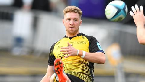 Angus O'Brien kicks the ball