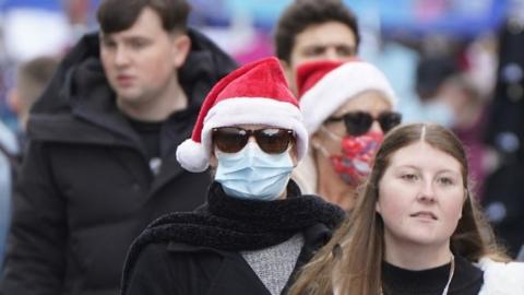 Woman in Santa hat and mask