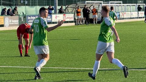 Ross Allen (left) celebrates scoring the 29th hat-trick of a Guernsey FC career stretching back almost 15 years