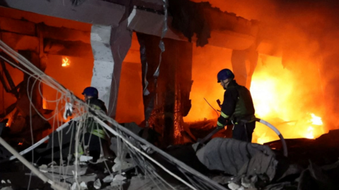 Firefighters in Dnipro after a missile strike on Friday