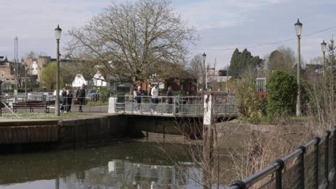 Image showing people walking across one of the locks over the Thames in Teddington