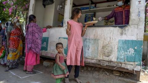 鶹Լless people receive free food offered by the Telangana state government during a 21-day government-imposed nationwide lockdown as a preventive measure against the COVID-19 coronavirus in Hyderabad