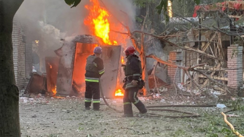 Firefighters tackle the blaze caused by a Russian missile attack in Zaporizhzhia