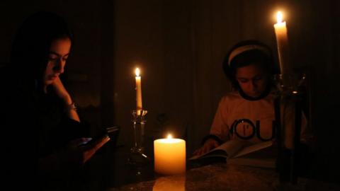 People light candles amid scorching summer heat as power outage crisis hit Tehran