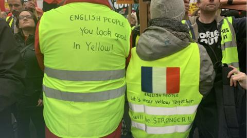 Erick Simon and Laurie Martin showing their yellow jackets