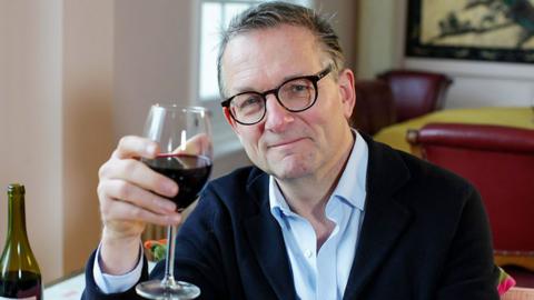 Michael Mosley with a glass of red wine