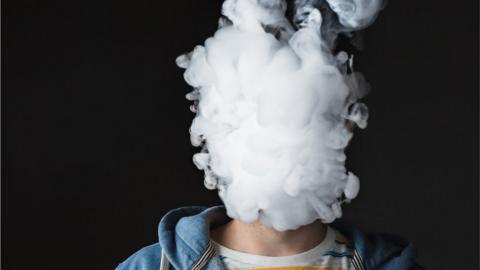 Man with face covered by vapour