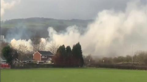 Smoke blowing over house