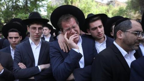 A man weeps at the funeral in Jerusalem of Avrohom Daniel Ambon, one of the 45 people killed in a crush at Lag B'Omer festival in northern Israel (3 May 2021)