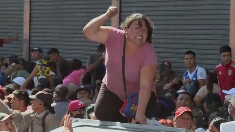 Protester on top of a rubbish bin