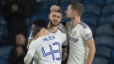 A tearful Mateusz Klich is hugged by Wilfried Gnonto and Leeds captain Liam Cooper