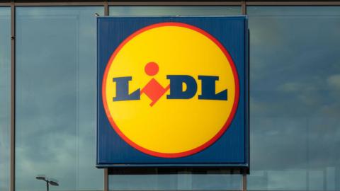 A general view picture of a yellow, blue and red Lidl sign.
