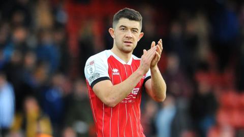 Cheltenham full-back Sean Long applauds the fans