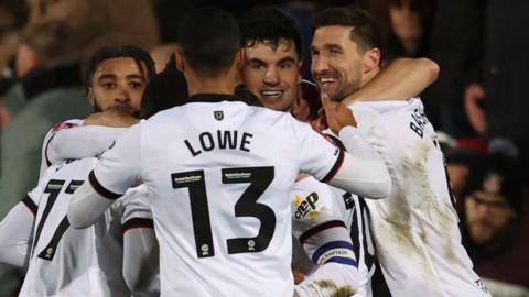 John Egan celebrates his late equaliser with team-mates