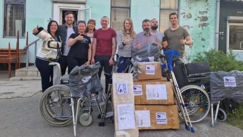 A group of people with the aid they brought to Ukraine