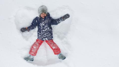 Child making a snow angel