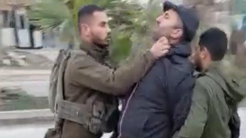 Screengrab of video from New Yorker journalist Lawrence Wright showing an Israeli soldier assaulting Palestinian activist Issa Amro in Hebron, in the occupied West Bank (13 February 2023)