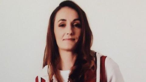 A picture of a woman in red and white jacket.