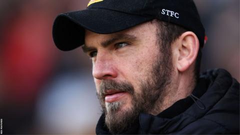 Gavin Gunning looks on from the touchline during a Swindon game