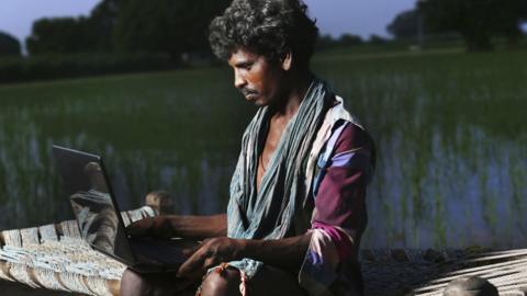 Young farmer in India using the internet