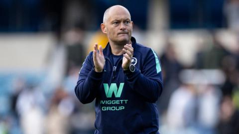 Millwall boss Alex Neil applauding fans after their 3-0 win over West Brom