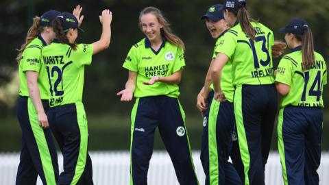 Ireland celebrate a wicket by Orla Prendergast