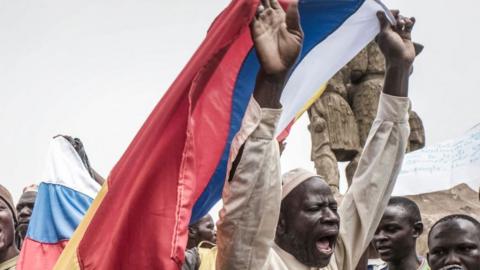 Russians and Malian flags are waved by protesters in Bamako, during a demonstration against French influence in the country on May 27, 2021.