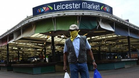 Man at Leicester Market with a mask on