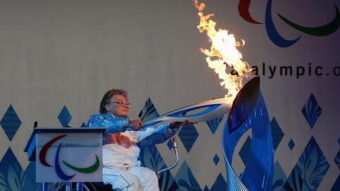Paralympian Caz Walton with Paralympic Heritage Flame