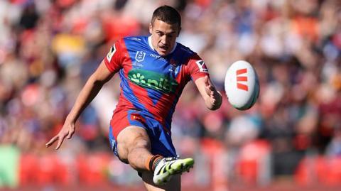 Jake Arthur kicks the ball while playing for Manly Sea Eagles