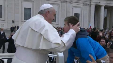 Pope kissing boy