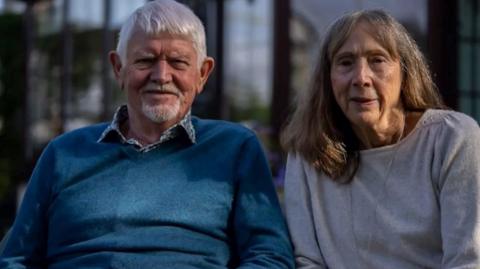 A husband and wife who have both had breast cancer have urged men to be aware of the symptoms.