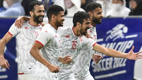 Tunisian players celebrate a goal against Japan at the Kirin Cup