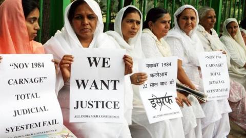 Relatives of victims of the 1984 riots hold placards demanding justice during a rally in Delhi, India. Photo: October 2018